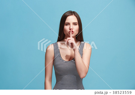 The young woman whispering a secret behind her 38523559