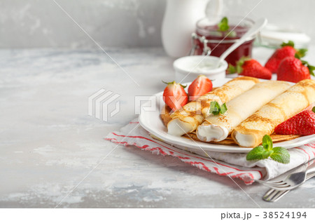 Thin hot pancakes with cottage cheese, jam Thin hot pancakes with cottage cheese, jam 38524194