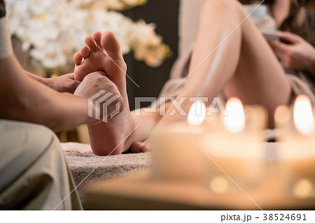 Woman having reflexology foot massage in wellness Woman having reflexology foot massage in wellness 38524691