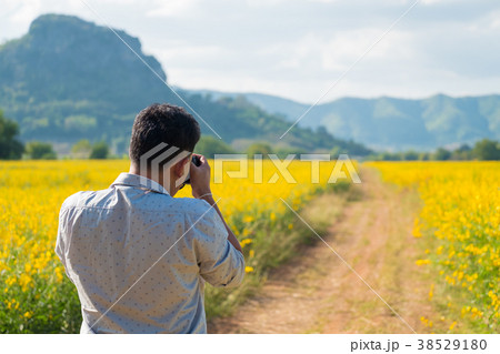 Rear view of photographer taking photo of nature 38529180