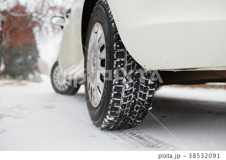 Closeup of car tires in winter. the first snow in 38532091