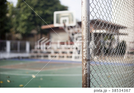 iron net fence fron of basketball court 38534367