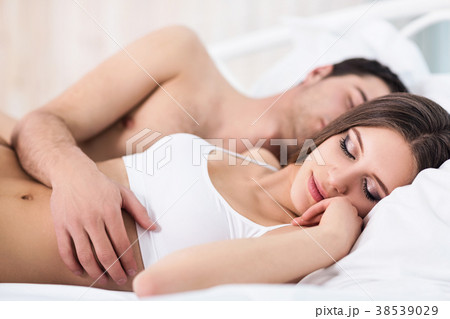 Couple sleeping in bed in the morning. 38539029