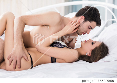 Young passionate couple making love in bed. 38539060