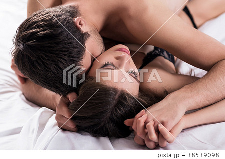 Young passionate couple making love in