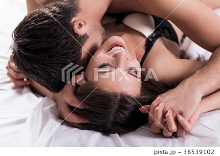 Young passionate couple making love in bed. Young passionate couple making love in bed. 38539102
