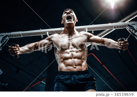 Brutal Caucasian bodybuilder training chest in gym 38539659