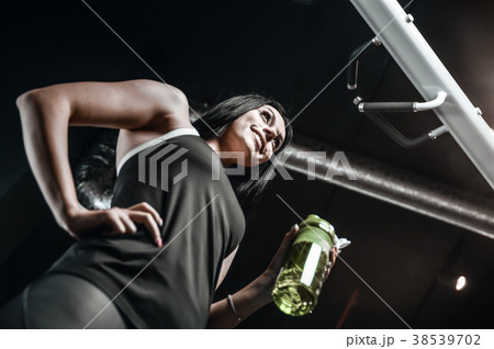 Sexy athletic young girl takes sport nutrition 38539702