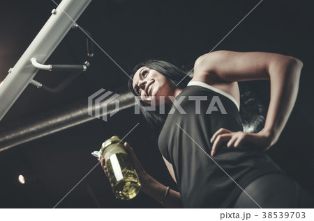 Sexy athletic young girl takes sport nutrition 38539703