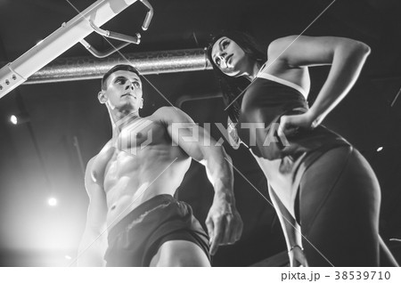 Model young man and woman working out in gym Model young man and woman working out in gym 38539710