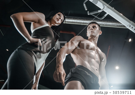 Model young man and woman working out in gym Model young man and woman working out in gym 38539711