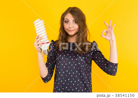 Attractive woman with energy saving bulb 38541150