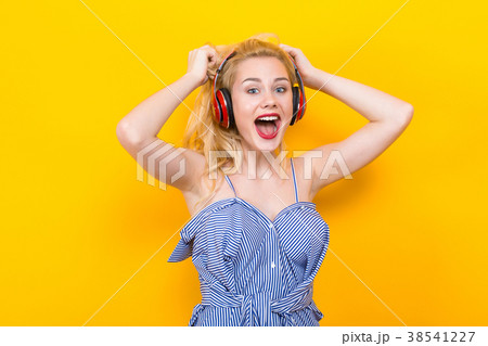 Blonde girl in blue striped blouse with headphones 38541227