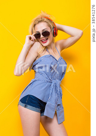 Girl in blouse with headphones and sunglasses 38541276