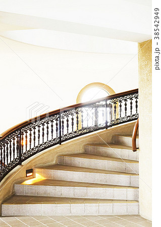 お洒落な洋館の螺旋階段と手すりと窓と光の写真素材