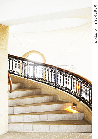 お洒落な洋館の螺旋階段と手すりと窓の写真素材