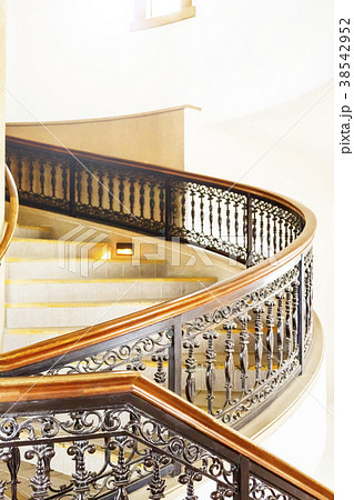 お洒落な洋館の螺旋階段と芸術的な手すりの写真素材