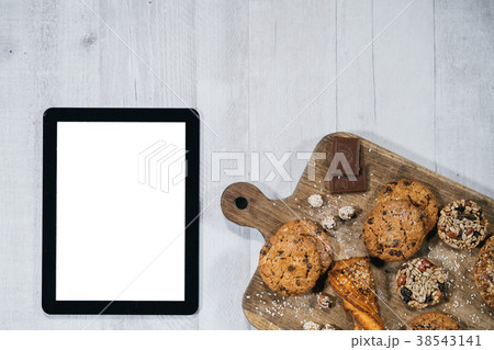 Fresh homemade cookies with tablet Fresh homemade cookies with tablet 38543141