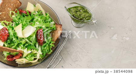 Frisee lettuce salad with sun dried tomatoes 38544098