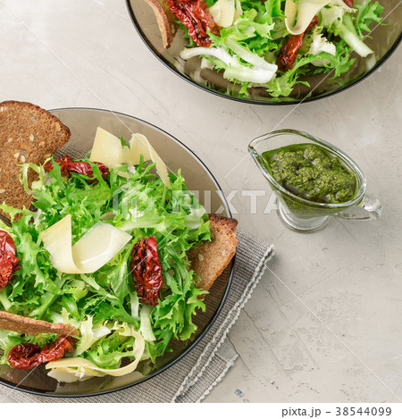 Frisee lettuce salad with sun dried tomatoes 38544099