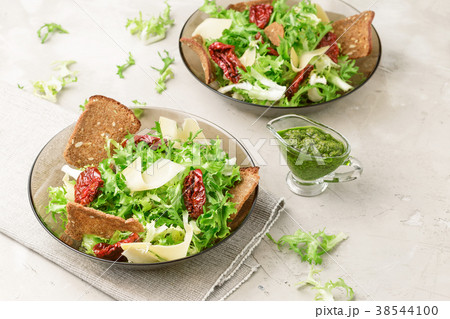 Frisee lettuce salad with sun dried tomatoes Frisee lettuce salad with sun dried tomatoes 38544100