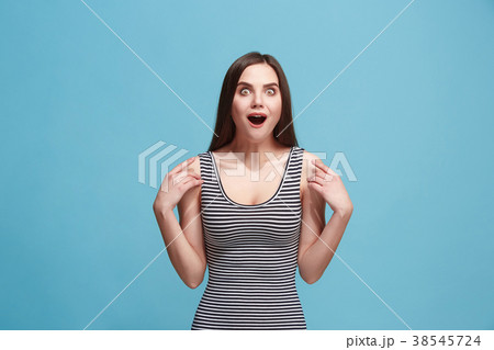 Beautiful woman looking suprised isolated on blue 38545724