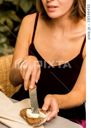 Young pretty girl makes sandwich of rye bread Young pretty girl makes sandwich of rye bread 38546450