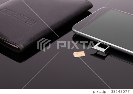 Smartphone and sim card on a dark background Smartphone and sim card on a dark background 38548077