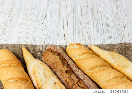 French baguette on the kitchen table. Close-up 38548582