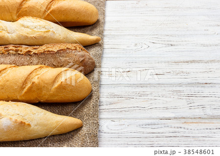 different types of baguette on a wooden background different types of baguette on a wooden background 38548601