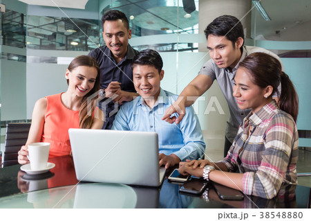 Multi-ethnic team of employees watching a funny 38548880