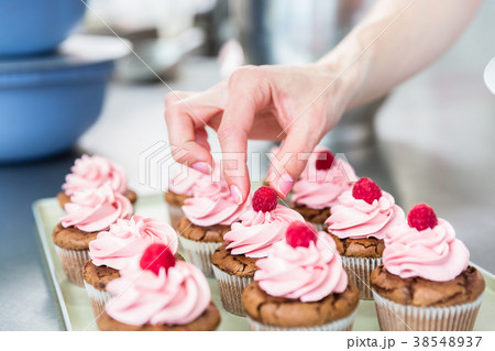 Women in pastry bakery working on muffins 38548937