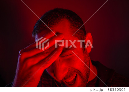 Man is suffering in pain from headache 38550305