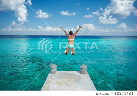 One woman jump in blue water 38551431