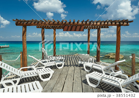 Wooden pier with white chairs Wooden pier with white chairs 38551432