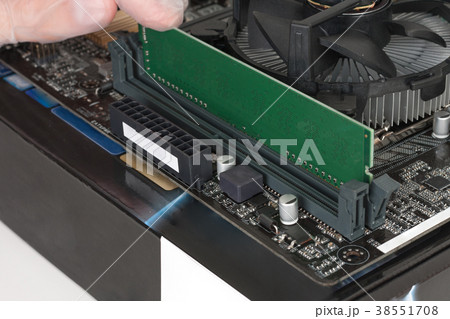 Close up of man hand installing Ram memory Close up of man hand installing Ram memory 38551708