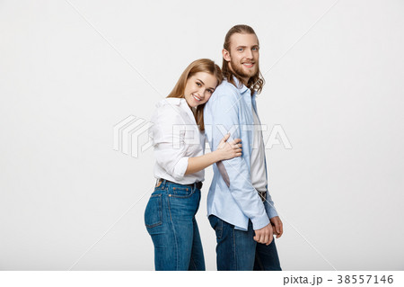 Portrait of cheerful young couple standing and Portrait of cheerful young couple standing and 38557146