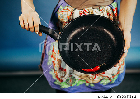 The girl with a frying pan. Are red sharp Chile 38558132