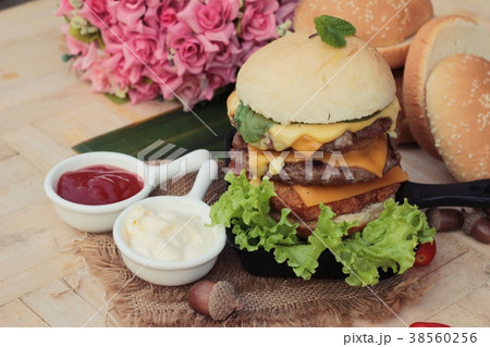 Double hamburger with double cheese is tasty. 38560256