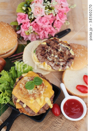 Double hamburger with double cheese is tasty. 38560270
