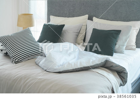 Messy bed with pillows in modern bedroom interior Messy bed with pillows in modern bedroom interior 38561035