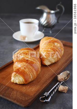 Two fresh croissants and cup of coffee Two fresh croissants and cup of coffee 38561966