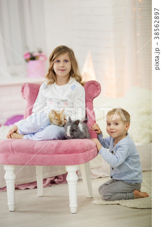 Pretty little girl with her brother at home are 38562897