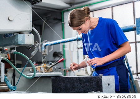 Stone carver applying ornament on headstone 38563959