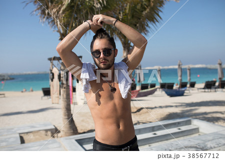 Attractive man with bare chest on the beach. 38567712