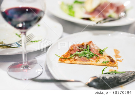 Last piece of pizza on white plate. Food scrap Last piece of pizza on white plate. Food scrap 38570594