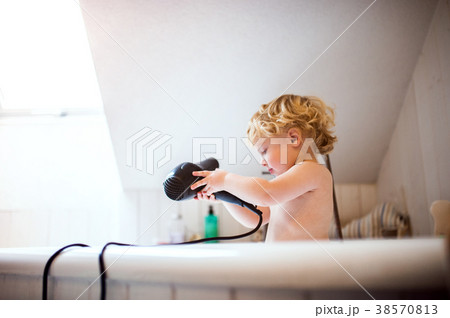Toddler boy with hairdryer in the tub in the Toddler boy with hairdryer in the tub in the 38570813
