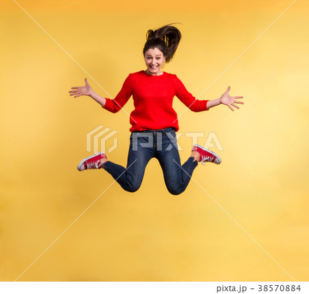 Young beautiful woman in studio, jumping. Young beautiful woman in studio, jumping. 38570884