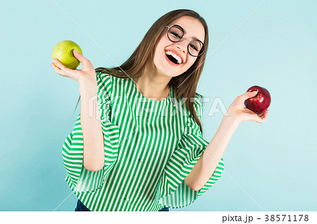 Young woman with two apples Young woman with two apples 38571178