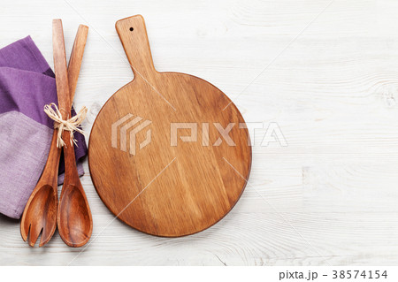 Cutting board over wooden table Cutting board over wooden table 38574154